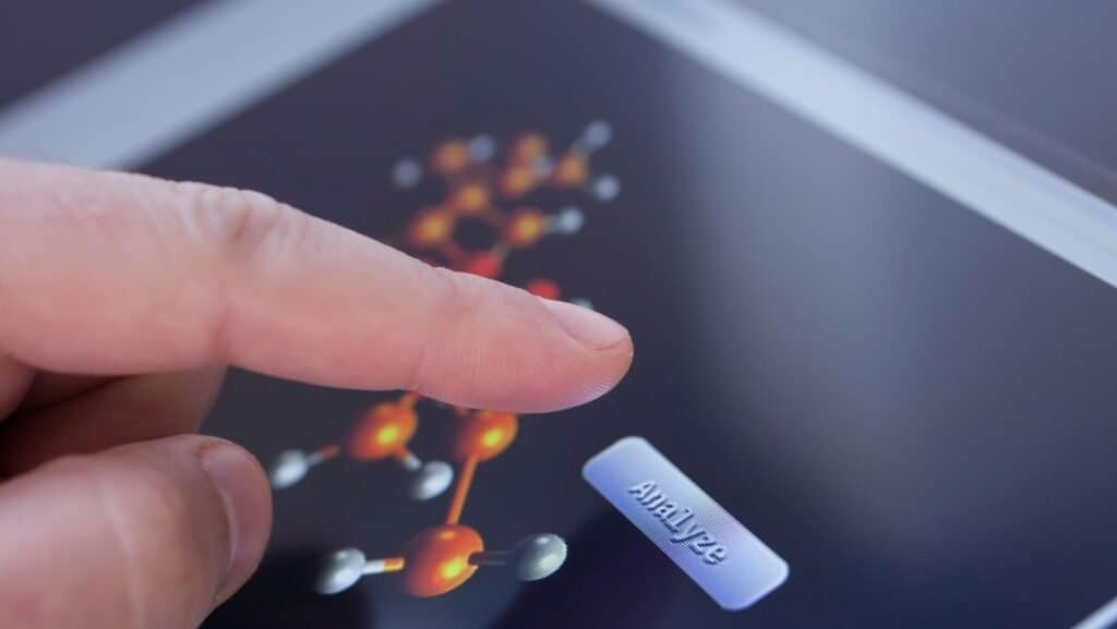 a finger touching a tablet automated chemistry analyzer