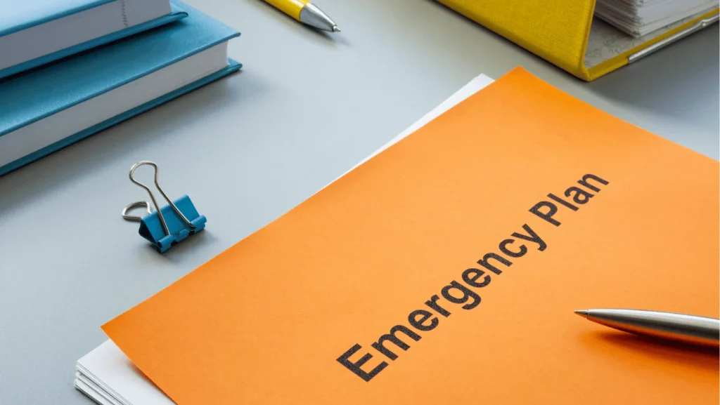 An emergency plan folder on a desk, signifying the importance of preparedness and immediate action in healthcare settings that employ point-of-care testing devices to rapidly assess critical conditions.