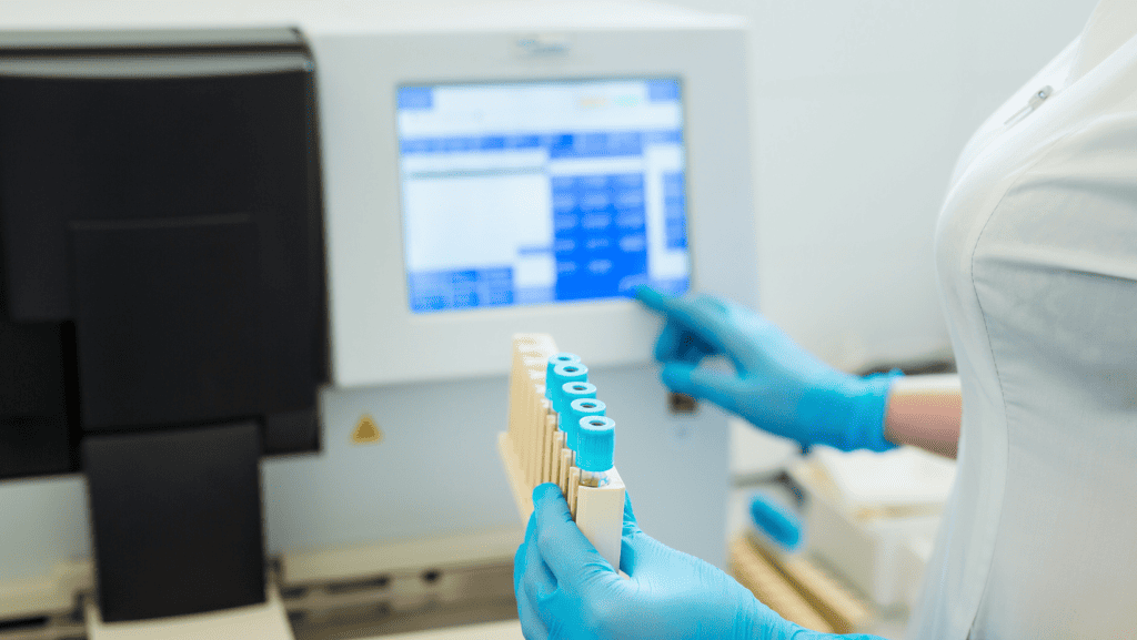 Medical scientist performing coagulation tests using advanced laboratory equipment