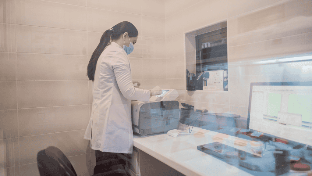 laboratory technician handling diagnostic equipment