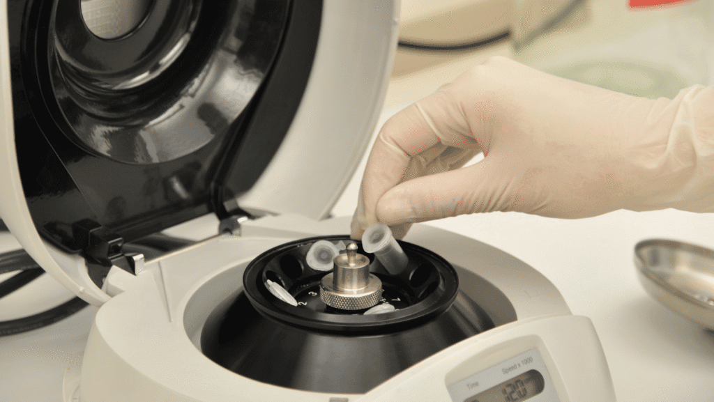 Gloved hands preparing POCT supplies and calibration tools