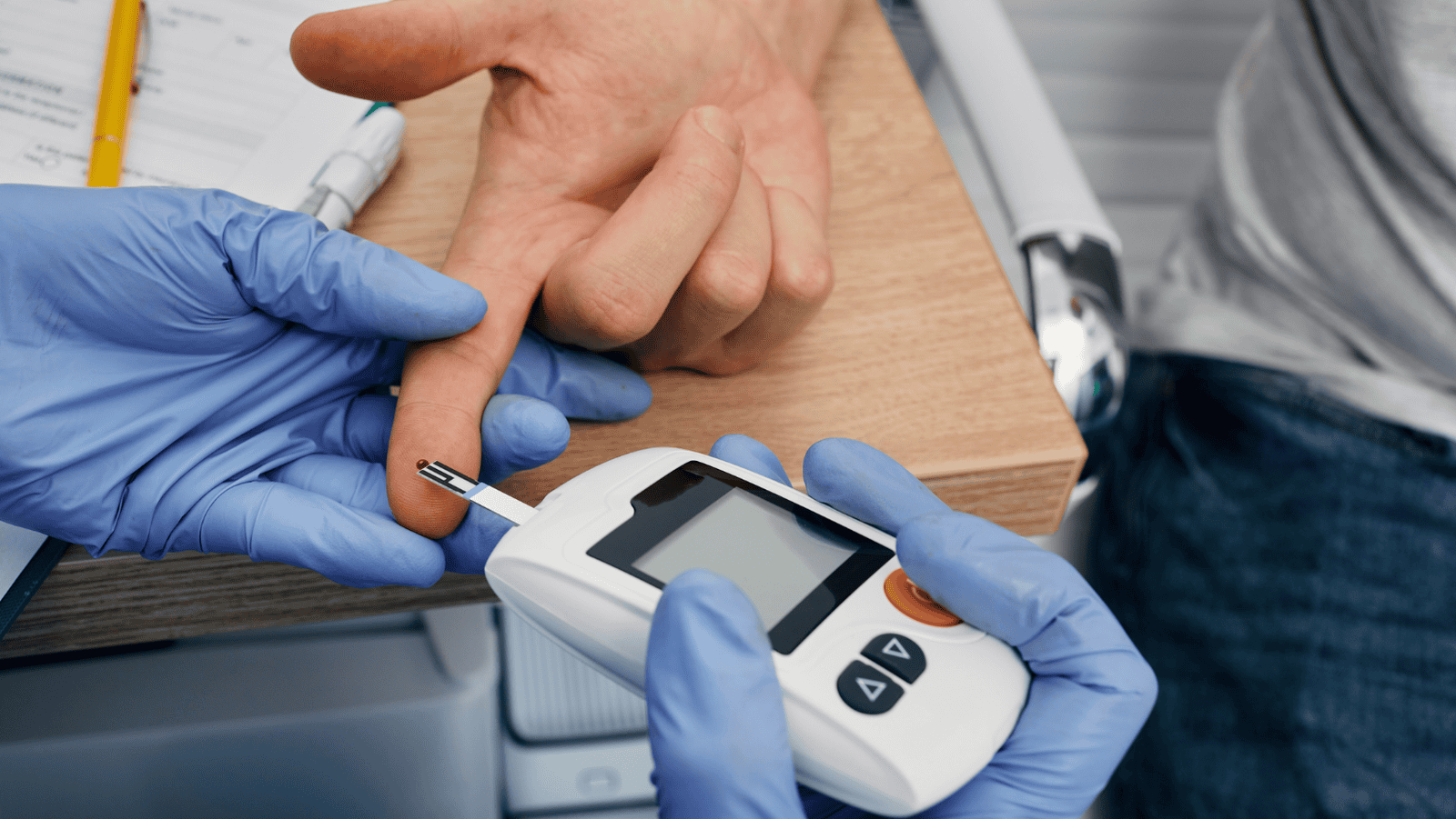 Medical technician performing point-of-care hemoglobin A1c test for diabetes management
